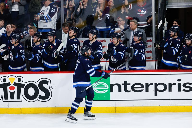 Mar 15, 2024; Winnipeg, Manitoba, CAN; Winnipeg Jets defenseman Dylan DeMelo (2) is congratulated by his team mates on his goal against the Anaheim Ducks during the third period at Canada Life Centre. Mandatory Credit: Terrence Lee-USA TODAY Sports