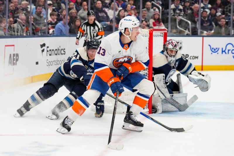 Feb 28, 2026; Columbus, Ohio, USA;  New York Islanders center Mathew Barzal (13) skates with the puck against Columbus Blue Jackets center Isac Lundeström (21) in the first period at Nationwide Arena. Mandatory Credit: Aaron Doster-Imagn Images