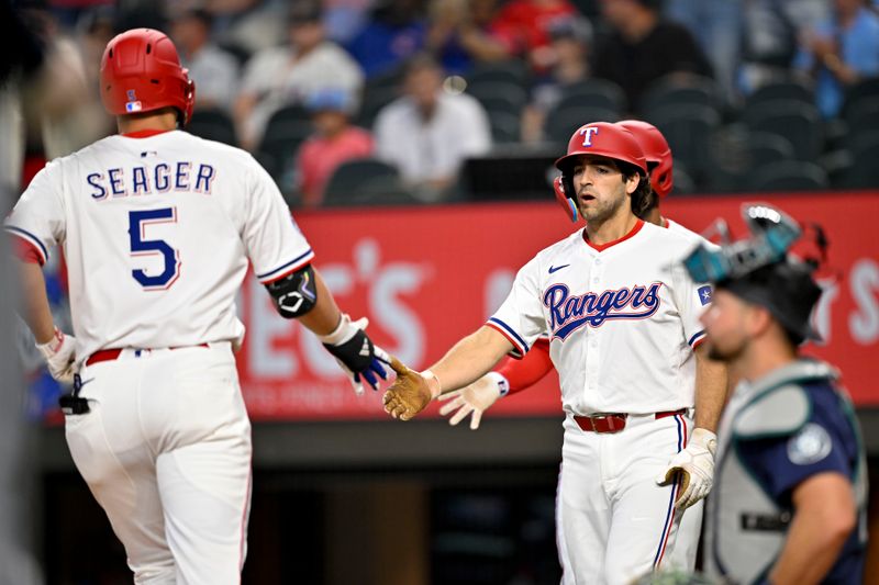 Jun 28, 2025; Arlington, Texas, USA; Texas Rangers shortstop Corey Seager (5) and first baseman Josh Smith (8) celebrate after Seager hits a two run home run against the Seattle Mariners during the third inning at Globe Life Field. Mandatory Credit: Jerome Miron-Imagn Images