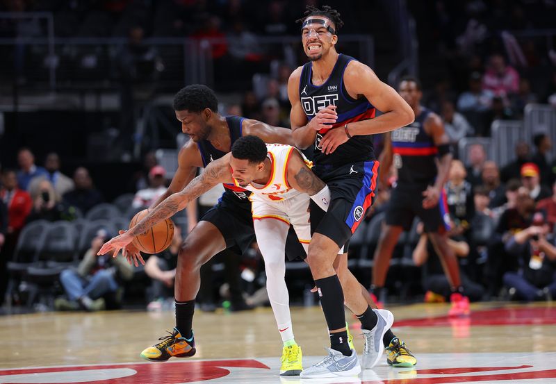 ATLANTA, GEORGIA - APRIL 03:  Tosan Evbuomwan #18 defends as Jaylen Nowell #5 of the Detroit Pistons steals the ball from Dejounte Murray #5 of the Atlanta Hawks during the fourth quarter at State Farm Arena on April 03, 2024 in Atlanta, Georgia.  NOTE TO USER: User expressly acknowledges and agrees that, by downloading and/or using this photograph, user is consenting to the terms and conditions of the Getty Images License Agreement.  (Photo by Kevin C. Cox/Getty Images)