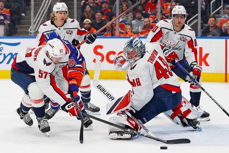 Jan 21, 2025; Edmonton, Alberta, CAN; Washington Capitals defensemen Trevor van Riemsdyk (57) clears the puck away from Edmonton Oilers forward Vasily Podkolzin (92) and an open net during the first period at Rogers Place. Mandatory Credit: Perry Nelson-Imagn Images