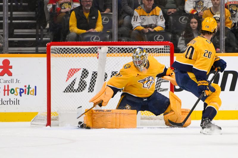 Feb 25, 2025; Nashville, Tennessee, USA;  Nashville Predators goaltender Juuse Saros (74) blocks the puck against the Florida Panthers during the first period at Bridgestone Arena. Mandatory Credit: Steve Roberts-Imagn Images