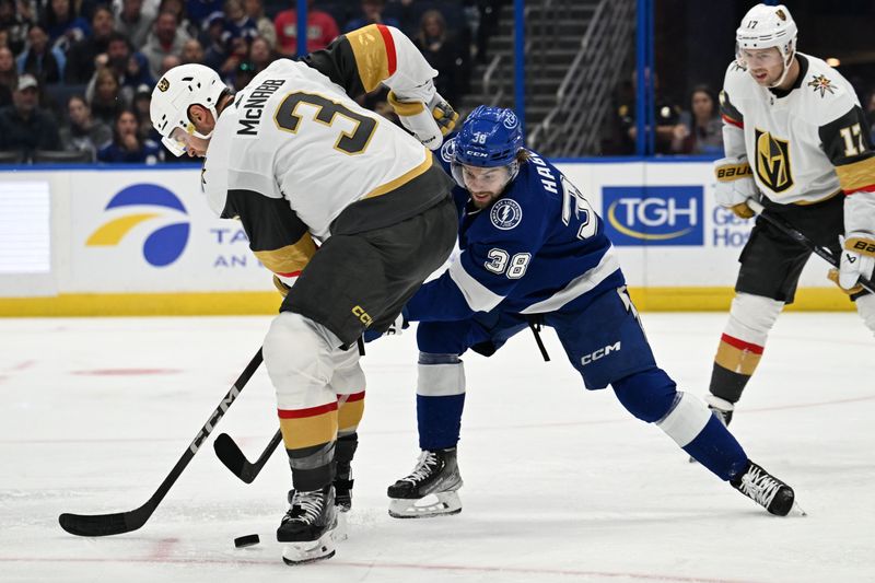 Dec 21, 2023; Tampa, Florida, USA; Tampa Bay Lightning left wing Brandon Hagel (38) attempts to get past Las Vegas Golden Knights defensemen Brayden McNabb (3) in the third period at Amalie Arena. Mandatory Credit: Jonathan Dyer-USA TODAY Sports