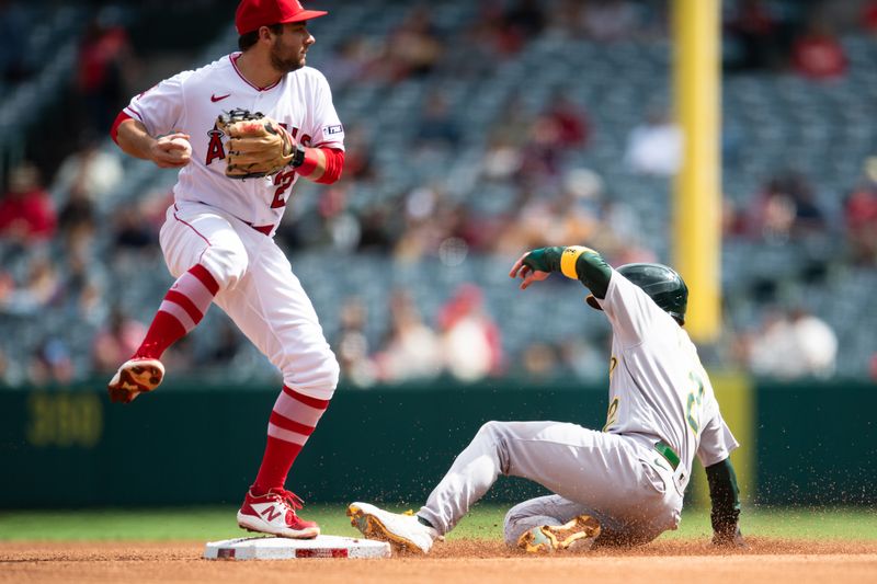 Oct 1, 2023; Anaheim, California, USA; Oakland Athletics shortstop Nick Allen (2) slides out at second base against Los Angeles Angels third baseman David Fletcher (22) during the third inning at Angel Stadium. Mandatory Credit: Jonathan Hui-USA TODAY Sports