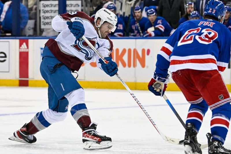 Feb 5, 2024; New York, New York, USA;  Colorado Avalanche left wing Miles Wood (28) shots while defended by New York Rangers defenseman Adam Fox (23) during the third period at Madison Square Garden. Mandatory Credit: Dennis Schneidler-USA TODAY Sports