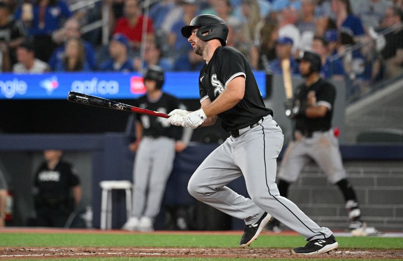 May 21, 2024; Toronto, Ontario, CAN;   Chicago White Sox shortstop Paul DeJong (29) hits a single against the Toronto Blue Jays in the eighth inning at Rogers Centre. Mandatory Credit: Dan Hamilton-USA TODAY Sports