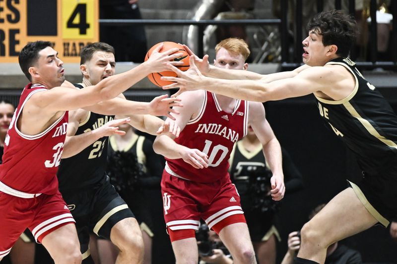 Jan 31, 2025; West Lafayette, Indiana, USA; Indiana Hoosiers guard Trey Galloway (32) and Purdue Boilermakers forward Raleigh Burgess (34) go after a loose ball during the first half at Mackey Arena. Mandatory Credit: Robert Goddin-Imagn Images