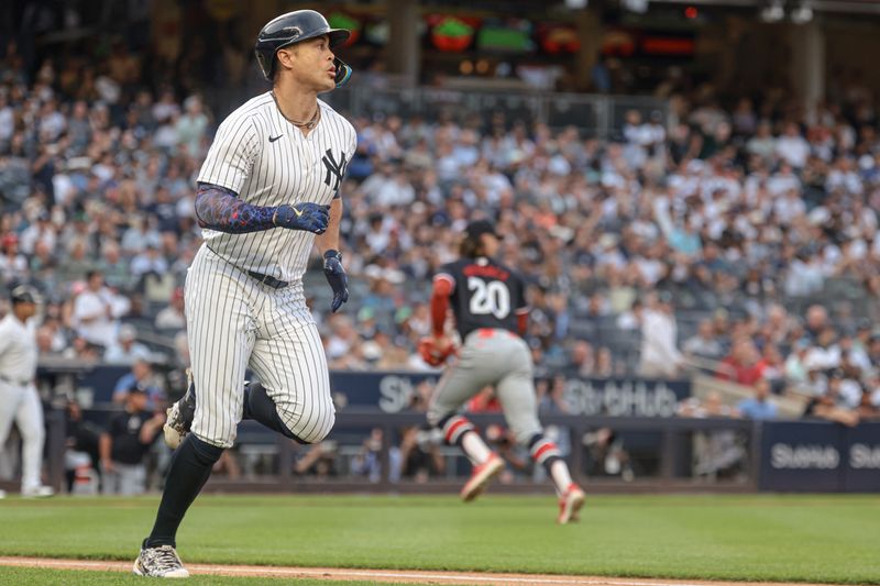 Jun 5, 2024; Bronx, New York, USA; New York Yankees designated hitter Giancarlo Stanton (27) hits an RBI single during the first inning against Minnesota Twins starting pitcher Chris Paddack (20) at Yankee Stadium. Mandatory Credit: Vincent Carchietta-USA TODAY Sports