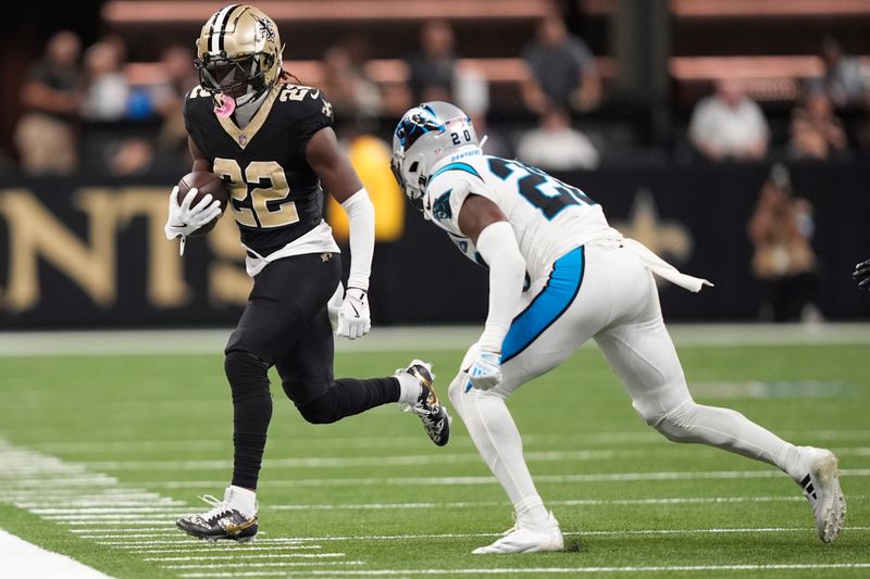 New Orleans Saints wide receiver Rashid Shaheed (22) runs the ball out of bounds past Carolina Panthers safety Jordan Fuller (20) during the first half of an NFL football game Sunday, Sept. 8, 2024, in New Orleans. (AP Photo/Gerald Herbert)