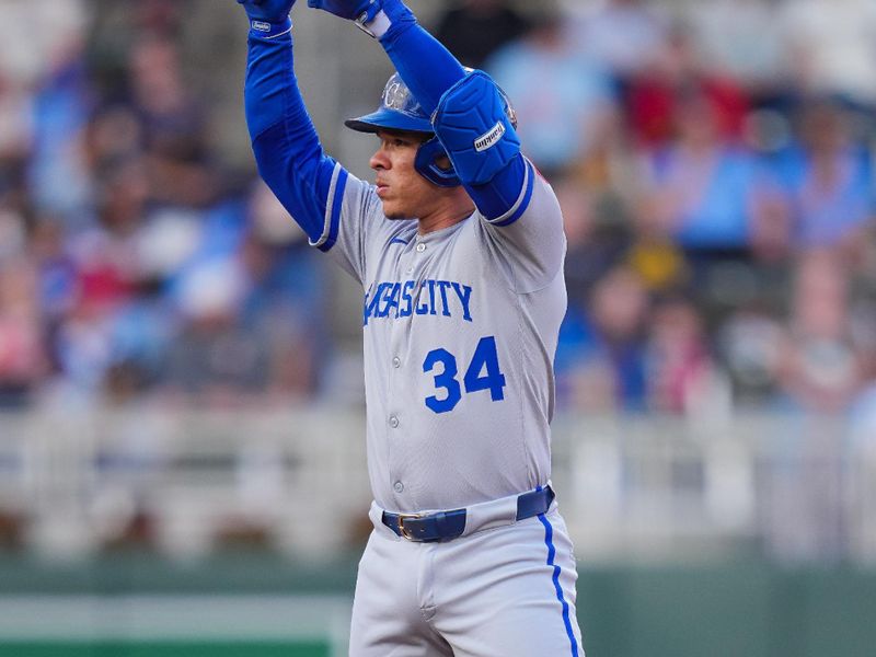 May 23, 2025; Minneapolis, Minnesota, USA; Kansas City Royals catcher Freddy Fermin (34) celebrates his double against the Minnesota Twins in the second inning at Target Field. Mandatory Credit: Brad Rempel-Imagn Images