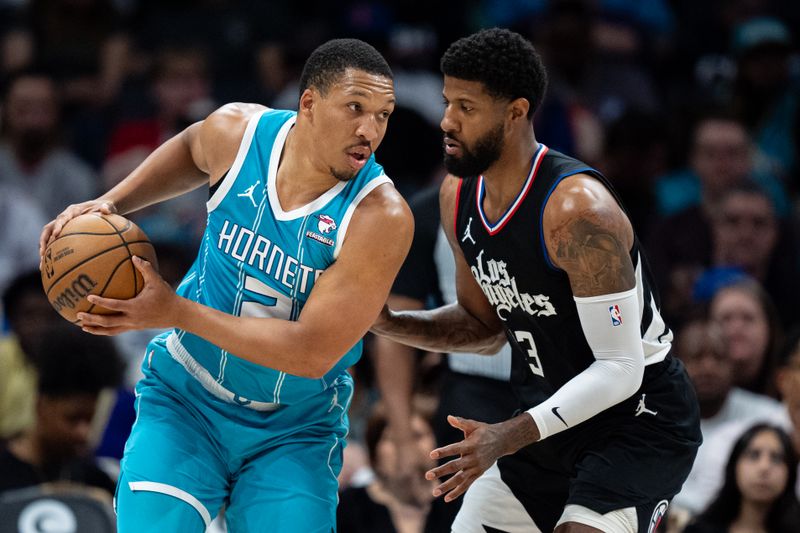 CHARLOTTE, NORTH CAROLINA - MARCH 31: Paul George #13 of the LA Clippers guards Grant Williams #2 of the Charlotte Hornets in the second quarter during their game at Spectrum Center on March 31, 2024 in Charlotte, North Carolina. NOTE TO USER: User expressly acknowledges and agrees that, by downloading and or using this photograph, User is consenting to the terms and conditions of the Getty Images License Agreement. (Photo by Jacob Kupferman/Getty Images)