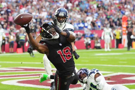 Arizona Cardinals wide receiver Marvin Harrison Jr. (18) can't holdout the ball during the second half of an NFL football game against the Seattle Seahawks, Sunday, Dec. 8, 2024, in Glendale, Ariz. (AP Photo/Ross D. Franklin)