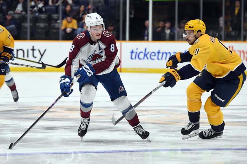 Mar 2, 2024; Nashville, Tennessee, USA; Colorado Avalanche defenseman Cale Makar (8) handles the puck against Nashville Predators left wing Filip Forsberg (9) during the second period at Bridgestone Arena. Mandatory Credit: Christopher Hanewinckel-USA TODAY Sports