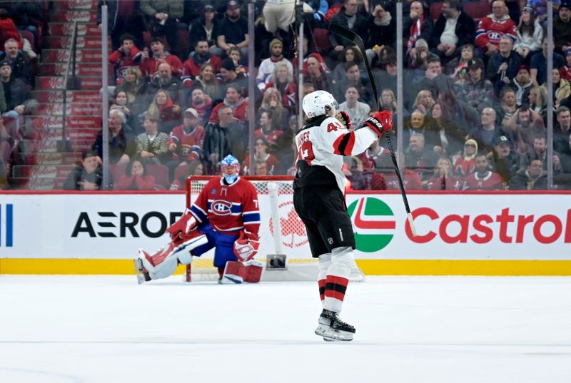 Jan 25, 2025; Montreal, Quebec, CAN; New Jersey Devils defenseman Luke Hughes (43) celebrates after scoring the winning goal against Montreal Canadiens goalie Jakub Dobes (75) during the overtime period at the Bell Centre. Mandatory Credit: Eric Bolte-Imagn Images