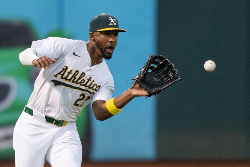 Aug 6, 2024; Oakland, California, USA;  Oakland Athletics outfielder Miguel Andujar (22) catches the ball during the sixth inning against the Chicago White Sox at Oakland-Alameda County Coliseum. Mandatory Credit: Stan Szeto-USA TODAY Sports