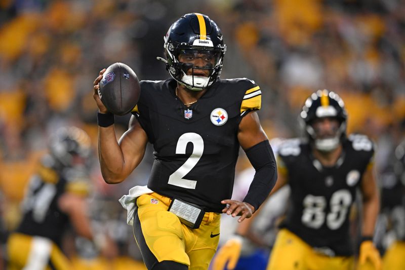 Pittsburgh Steelers quarterback Justin Fields (2) scrambles with the ball during the first half of an NFL preseason football game against the Buffalo Bills, Saturday, Aug. 17, 2024, in Pittsburgh. (AP Photo/David Dermer)