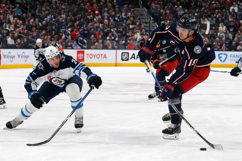 Nov 1, 2024; Columbus, Ohio, USA; Columbus Blue Jackets center Adam Fantilli (19) wrists a shot on goal as Winnipeg Jets defenseman Dylan DeMelo (2) trails the play during the second period at Nationwide Arena. Mandatory Credit: Russell LaBounty-Imagn Images