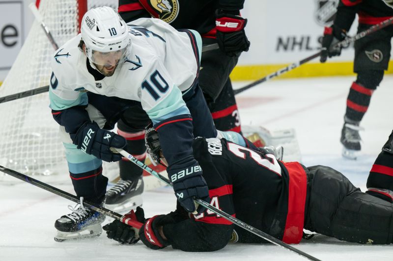 Nov 2, 2024; Ottawa, Ontario, CAN; Seattle Kraken center Matty Beniers (10) skates over Ottawa Senators defenseman Jacob Bernard-Docker (24) in the second period at the Canadian Tire Centre. Mandatory Credit: Marc DesRosiers-Imagn Images