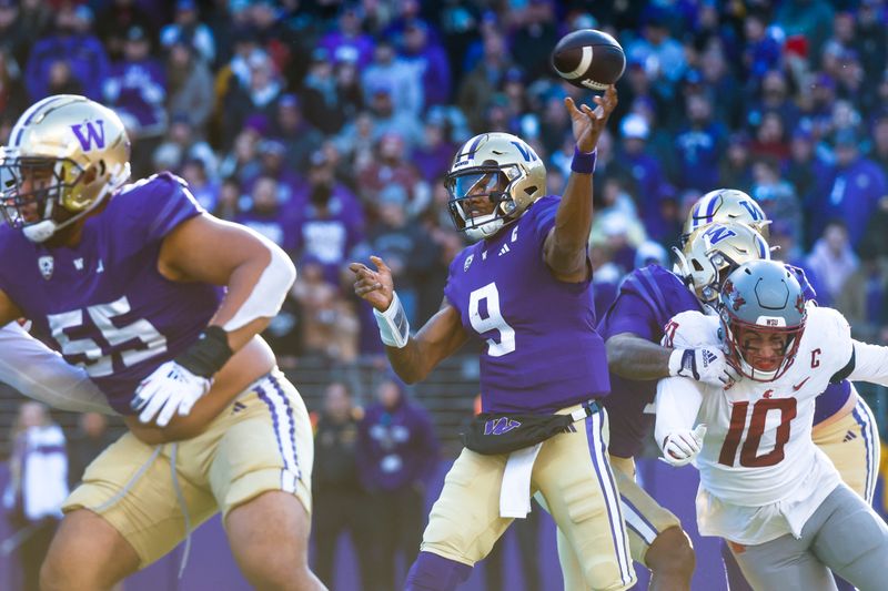 Nov 25, 2023; Seattle, Washington, USA; Washington Huskies quarterback Michael Penix Jr. (9) passes against the Washington State Cougars during the second quarter at Alaska Airlines Field at Husky Stadium. Mandatory Credit: Joe Nicholson-USA TODAY Sports