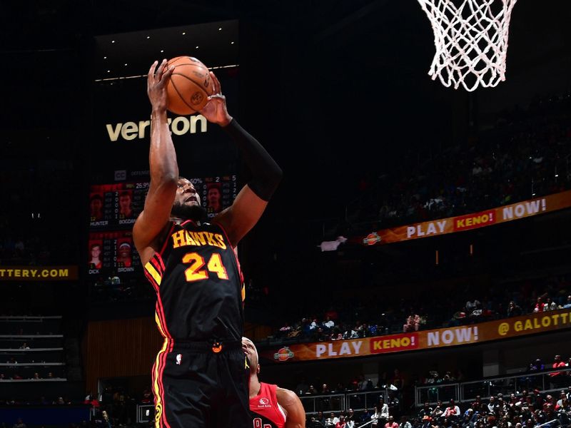 ATLANTA, GA - February 23: Bruno Fernando #24 of the Atlanta Hawks drives to the basket during the game against the Toronto Raptors on February 23, 2024 at State Farm Arena in Atlanta, Georgia.  NOTE TO USER: User expressly acknowledges and agrees that, by downloading and/or using this Photograph, user is consenting to the terms and conditions of the Getty Images License Agreement. Mandatory Copyright Notice: Copyright 2024 NBAE (Photo by Scott Cunningham/NBAE via Getty Images)