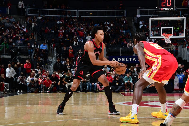 ATLANTA, GA - JANUARY 28: Scottie Barnes #4 of the Toronto Raptors handles the ball against Clint Capela #15 of the Atlanta Hawks during the game on January 28, 2024 at State Farm Arena in Atlanta, Georgia.  NOTE TO USER: User expressly acknowledges and agrees that, by downloading and/or using this Photograph, user is consenting to the terms and conditions of the Getty Images License Agreement. Mandatory Copyright Notice: Copyright 2024 NBAE (Photo by Scott Cunningham/NBAE via Getty Images)