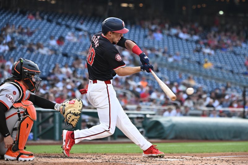 Aug 5, 2024; Washington, District of Columbia, USA; Washington Nationals center fielder Jacob Young (30) hits the ball into play against the San Francisco Giants during the third inning at Nationals Park. Mandatory Credit: Rafael Suanes-USA TODAY Sports