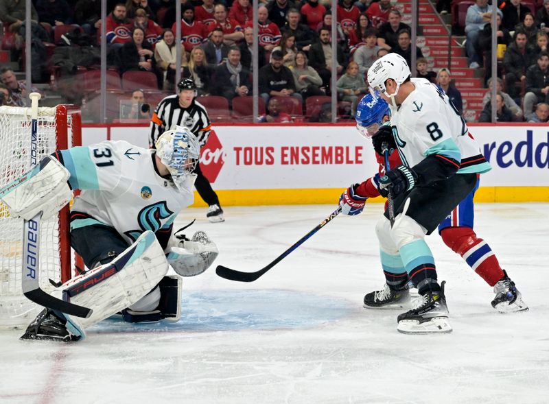 Dec 4, 2023; Montreal, Quebec, CAN; Montreal Canadiens forward Tanner Pearson (70) scores a goal against Seattle Kraken goalie Philipp Grubauer (31) during the second period at the Bell Centre. Mandatory Credit: Eric Bolte-USA TODAY Sports