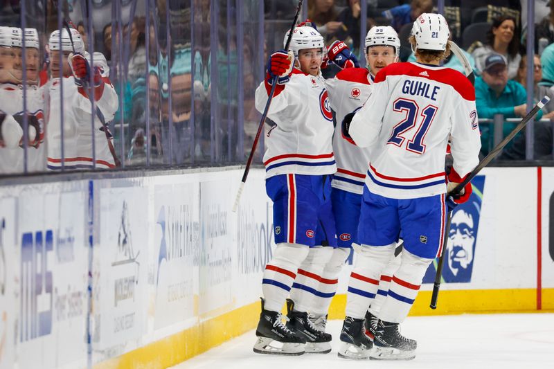 Mar 24, 2024; Seattle, Washington, USA; Montreal Canadiens center Alex Newhook (15, left) celebrates with left wing Michael Pezzetta (55) and defenseman Kaiden Guhle (21) after scoring a goal against the Seattle Kraken during the first period at Climate Pledge Arena. Mandatory Credit: Joe Nicholson-USA TODAY Sports