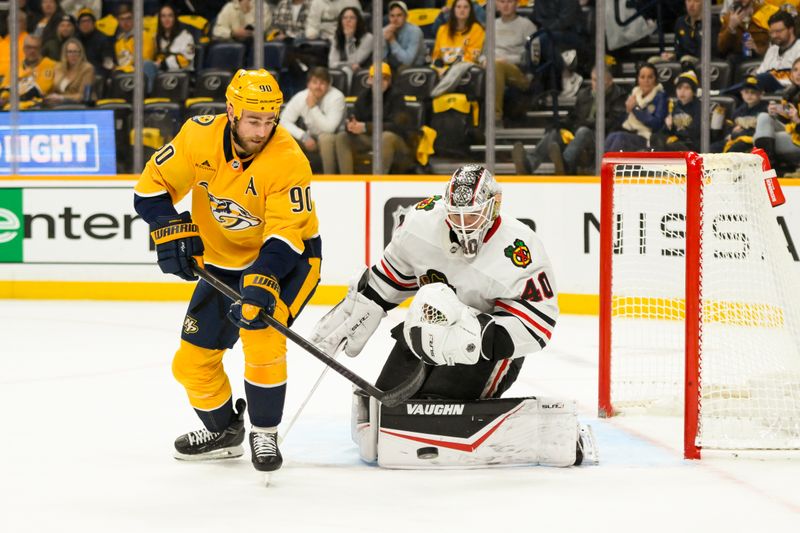 Jan 16, 2025; Nashville, Tennessee, USA;  Chicago Blackhawks goaltender Arvid Soderblom (40) blocks the shot of Nashville Predators center Ryan O'Reilly (90) during the first period at Bridgestone Arena. Mandatory Credit: Steve Roberts-Imagn Images