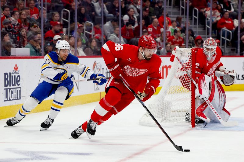 Mar 16, 2024; Detroit, Michigan, USA;  Detroit Red Wings defenseman Jake Walman (96) skates with the puck chased by Buffalo Sabres center Tyson Jost (17) in the first period at Little Caesars Arena. Mandatory Credit: Rick Osentoski-USA TODAY Sports