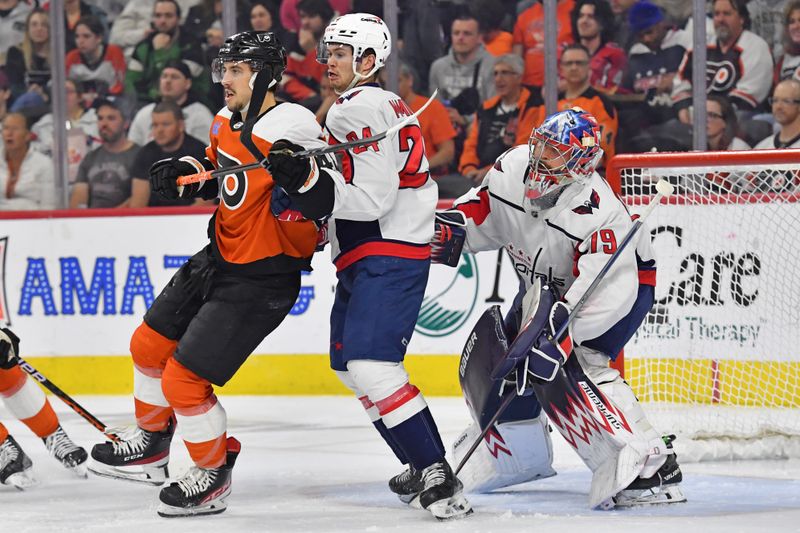 Apr 16, 2024; Philadelphia, Pennsylvania, USA; Philadelphia Flyers center Morgan Frost (48) and Washington Capitals center Connor McMichael (24) battle for position in front of goaltender Charlie Lindgren (79) during the second period at Wells Fargo Center. Mandatory Credit: Eric Hartline-USA TODAY Sports