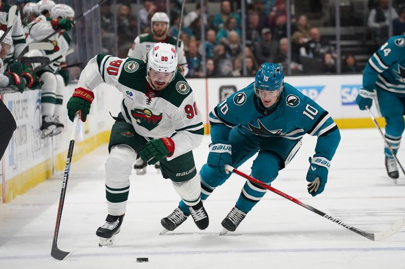 Apr 13, 2024; San Jose, California, USA; Minnesota Wild center Marcus Johansson (90) controls the puck against San Jose Sharks center Klim Kostin (10) during the first period at SAP Center at San Jose. Mandatory Credit: David Gonzales-USA TODAY Sports