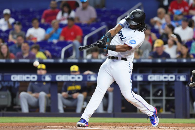 Sep 24, 2023; Miami, Florida, USA; Miami Marlins first baseman Josh Bell (9) hits a single against the Milwaukee Brewers during the first inning at loanDepot Park. Mandatory Credit: Sam Navarro-USA TODAY Sports