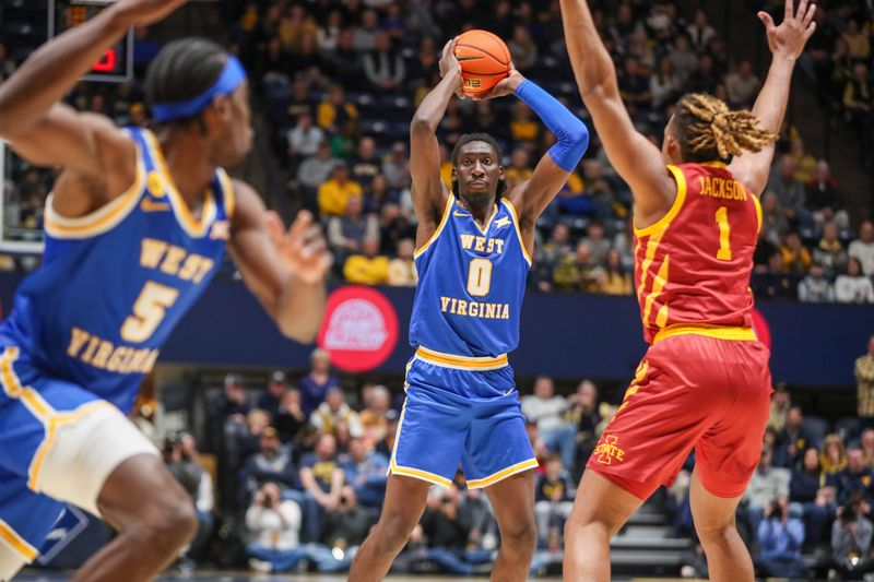 Jan 18, 2025; Morgantown, West Virginia, USA; West Virginia Mountaineers center Eduardo Andre (0) passes the ball while defended by Iowa State Cyclones center Dishon Jackson (1) during the first half at WVU Coliseum. Mandatory Credit: Ben Queen-Imagn Images