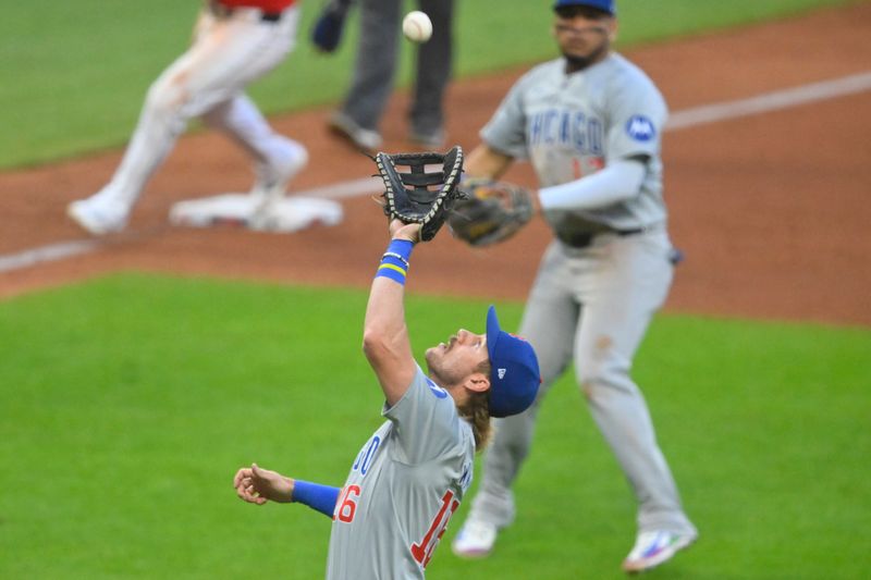 Aug 13, 2024; Cleveland, Ohio, USA; Chicago Cubs first baseman Patrick Wisdom (16) catches a pop fly in the fifth inning against the Cleveland Guardians at Progressive Field. Mandatory Credit: David Richard-USA TODAY Sports