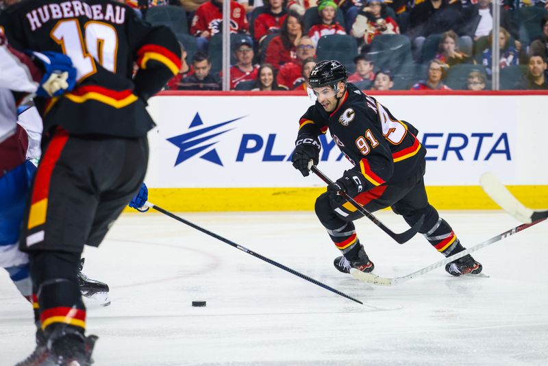 Mar 12, 2024; Calgary, Alberta, CAN; Calgary Flames center Nazem Kadri (91) controls the puck against the Colorado Avalanche during the second period at Scotiabank Saddledome. Mandatory Credit: Sergei Belski-USA TODAY Sports