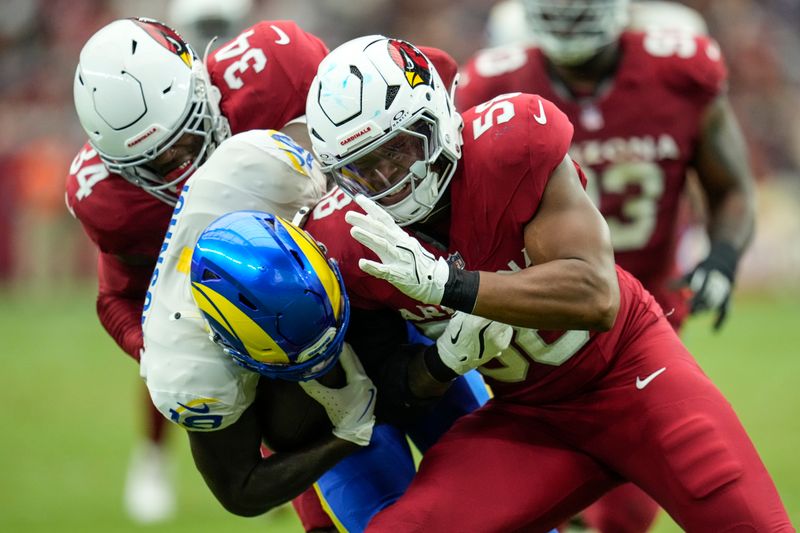 Arizona Cardinals linebacker Julian Okwara (58) hits Los Angeles Rams wide receiver Tyler Johnson (18) during the first half of an NFL football game, Sunday, Sept. 15, 2024, in Glendale, Ariz. (AP Photo/Ross D. Franklin)