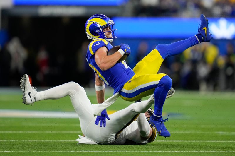 Los Angeles Rams wide receiver Cooper Kupp, top, makes a catch over New Orleans Saints linebacker Pete Werner during the first half of an NFL football game Thursday, Dec. 21, 2023, in Inglewood, Calif. (AP Photo/Ashley Landis)