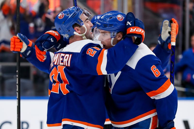 Apr 6, 2024; Elmont, New York, USA; New York Islanders center Kyle Palmieri (21) celebrates with defenseman Ryan Pulock (6) after scoring an empty net goal against the Nashville Predators during the third period at UBS Arena. Mandatory Credit: Tom Horak-USA TODAY Sports