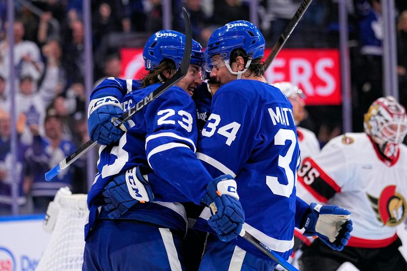 Apr 20, 2025; Toronto, Ontario, CAN; Toronto Maple Leafs forward Auston Matthews (34) congratulates forward Matthew Knies (23) on his goal against the Ottawa Senators during the third period of game one of the first round of the 2025 Stanley Cup Playoffs at Scotiabank Arena. Mandatory Credit: John E. Sokolowski-Imagn Images