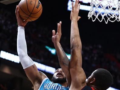 MIAMI, FLORIDA - DECEMBER 13: Miles Bridges #0 of the Charlotte Hornets drives against Orlando Robinson #25 of the Miami Heat during the third quarter at Kaseya Center on December 13, 2023 in Miami, Florida. NOTE TO USER: User expressly acknowledges and agrees that, by downloading and or using this photograph, User is consenting to the terms and conditions of the Getty Images License Agreement. (Photo by Megan Briggs/Getty Images)