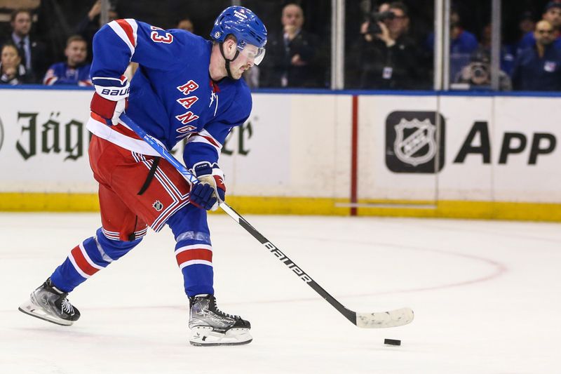 Nov 12, 2023; New York, New York, USA; New York Rangers left wing Alexis Lafreniere (13) scores the game winning goal in a shootout against the Columbus Blue Jackets at Madison Square Garden. Mandatory Credit: Wendell Cruz-USA TODAY Sports