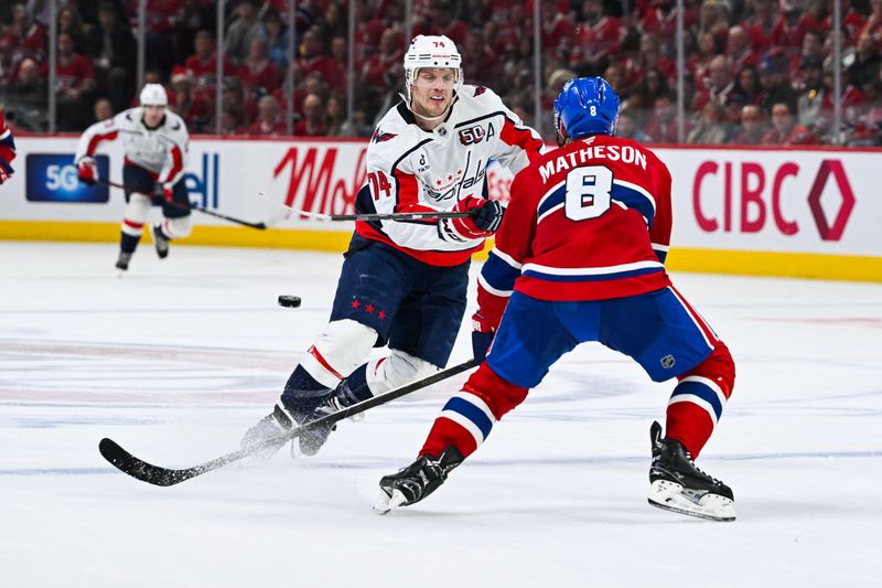 Apr 27, 2025; Montreal, Quebec, CAN; Washington Capitals defenseman John Carlson (74) shoots the puck beside Montreal Canadiens defenseman Mike Matheson (8) during the second period in game four of the first round of the 2025 Stanley Cup Playoffs at Bell Centre. Mandatory Credit: David Kirouac-Imagn Images