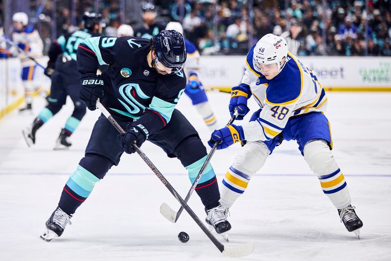 Dec 14, 2025; Seattle, Washington, USA;  Seattle Kraken center Chandler Stephenson (9) and Buffalo Sabres center Tyson Kozak (48) battle for the puck during the second period at Climate Pledge Arena. Mandatory Credit: Blake Dahlin-Imagn Images