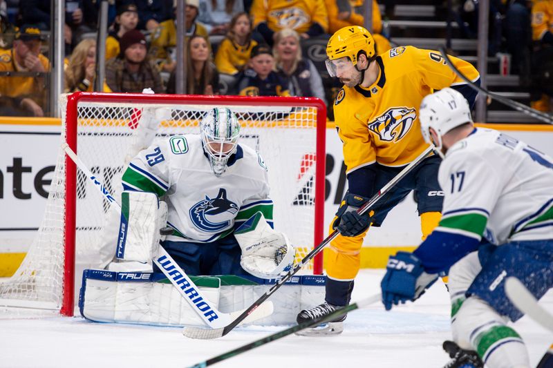 Apr 26, 2024; Nashville, Tennessee, USA; Vancouver Canucks goaltender Casey DeSmith (29) blocks the deflection of Nashville Predators left wing Filip Forsberg (9) during the third period in game three of the first round of the 2024 Stanley Cup Playoffs at Bridgestone Arena. Mandatory Credit: Steve Roberts-USA TODAY Sports