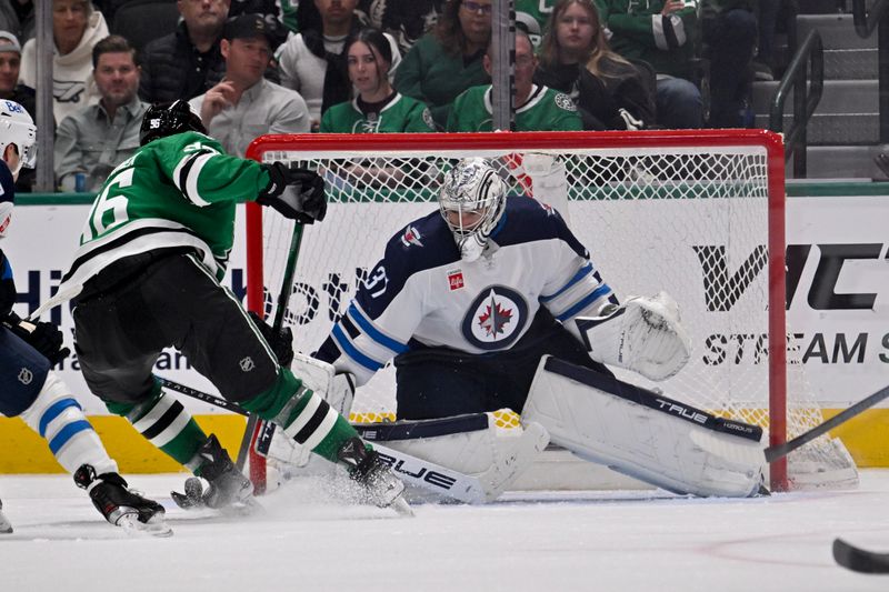 Apr 10, 2025; Dallas, Texas, USA; Winnipeg Jets goaltender Connor Hellebuyck (37) stops a breakaway shot by Dallas Stars right wing Mikko Rantanen (96) during the third period at the American Airlines Center. Mandatory Credit: Jerome Miron-Imagn Images