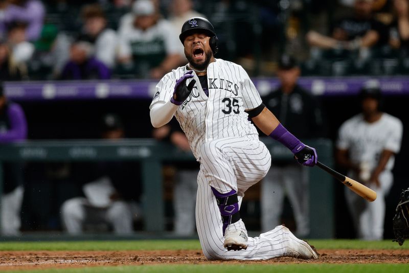 Apr 24, 2024; Denver, Colorado, USA; Colorado Rockies catcher Elias Diaz (35) reacts after hitting a ball off his foot in the eighth inning against the San Diego Padres at Coors Field. Mandatory Credit: Isaiah J. Downing-USA TODAY Sports