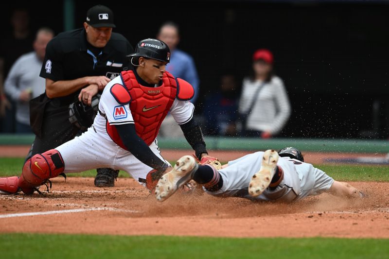 Oct 12, 2024; Cleveland, Ohio, USA; Detroit Tigers shortstop Trey Sweeney (27) under the tag form catcher Bo Naylor (23) in the fifth inning  during game five of the ALDS for the 2024 MLB Playoffs at Progressive Field. Mandatory Credit: Ken Blaze-Imagn Images