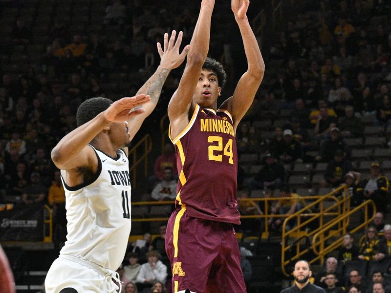 Feb 11, 2024; Iowa City, Iowa, USA; Minnesota Golden Gophers guard Cam Christie (24) shoots the ball over Iowa Hawkeyes guard Tony Perkins (11) during the first half at Carver-Hawkeye Arena. Mandatory Credit: Jeffrey Becker-USA TODAY Sports