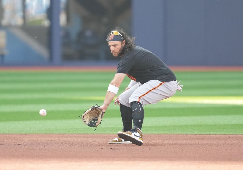 Jun 29, 2023; Toronto, Ontario, CAN; San Francisco Giants shortstop Brandon Crawford (35) fields balls during batting practice against the Toronto Blue Jays at Rogers Centre. Mandatory Credit: Nick Turchiaro-USA TODAY Sports